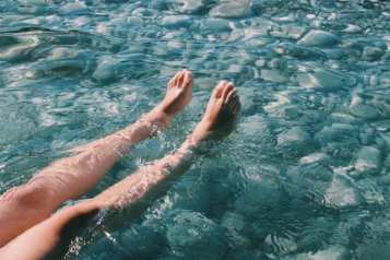 Feet in turquoise water