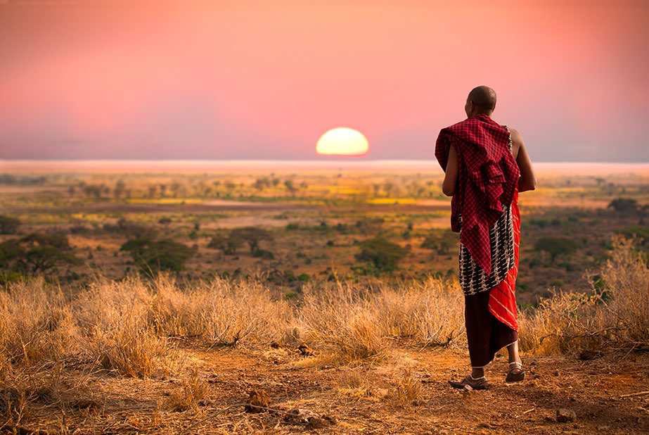 A Maasai elder watching the sunset over the plains