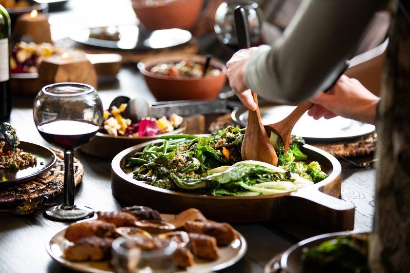 A shared feast of garden greens and slow-cooked dishes