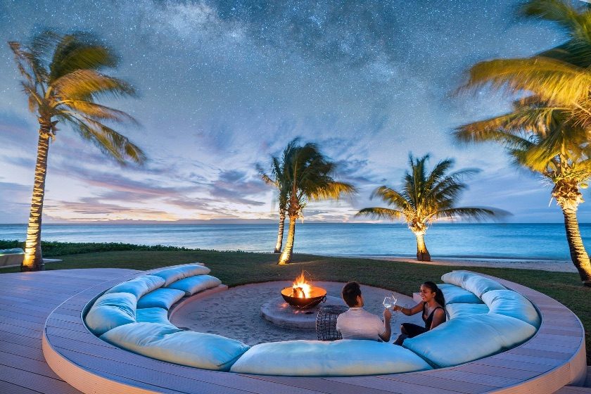 A firepit lounge under a starlit island sky