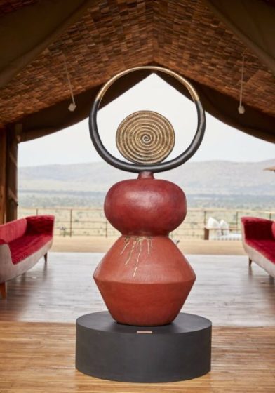 A sculpture framing the Serengeti from a tented lounge