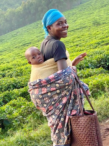 A tea picker and her child in the Rwandan hills